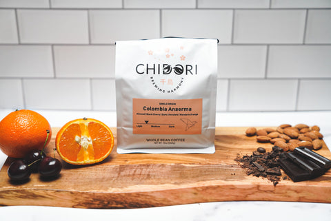 Colombia Anserma. This is Colombian Coffee that has a roasting profile of light to medium. Flavor notes include Almond, Black Cherry, Dark Chocolate & Mandarin Orange.